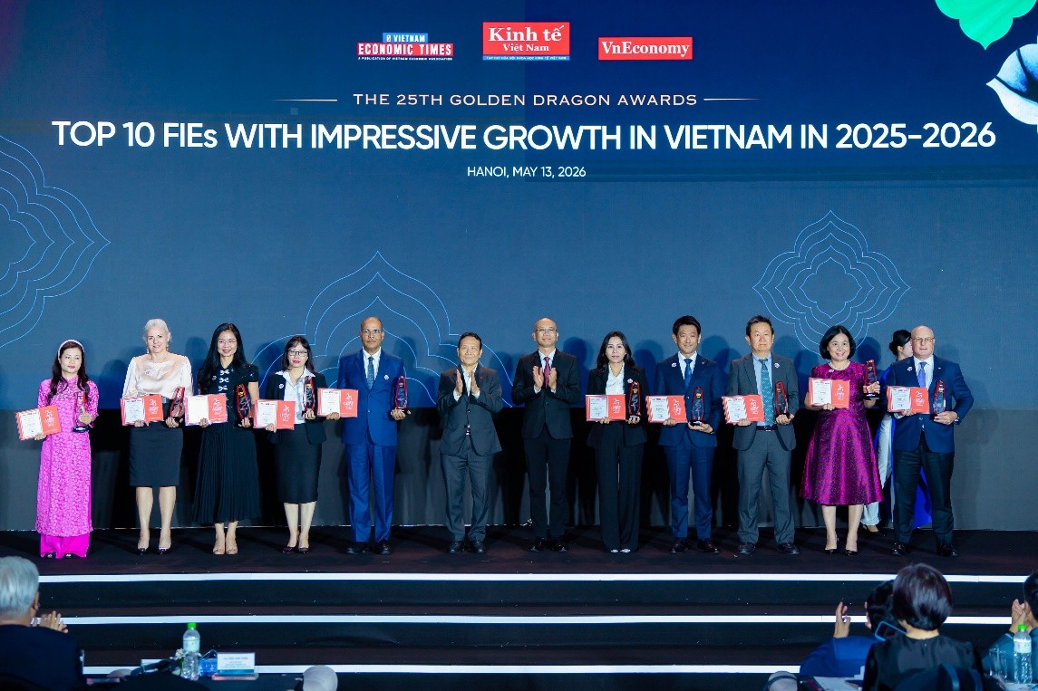 A group of people standing on a stage holding awards
Description automatically generated