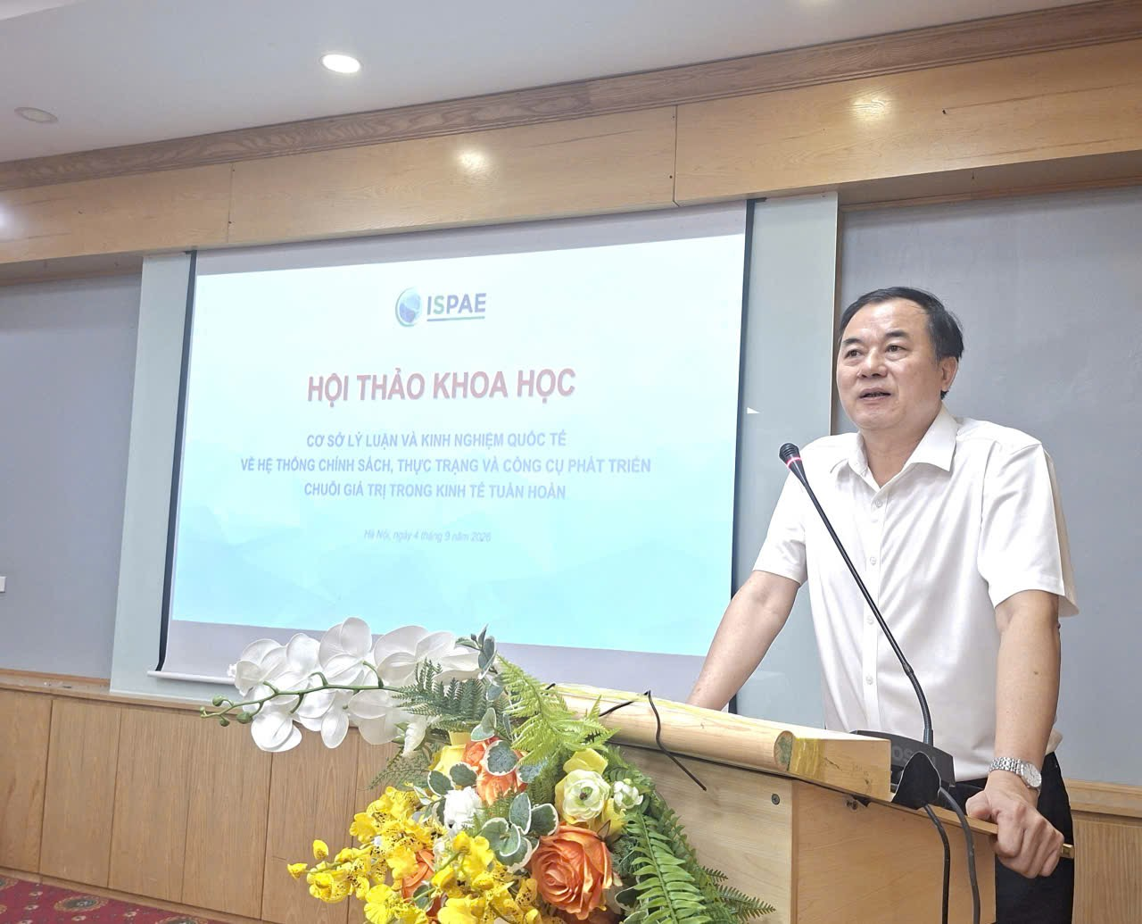 A person standing at a podium with a microphoneDescription automatically generated